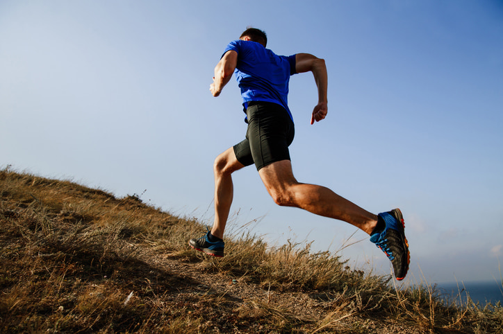 Athlete running uphill in nature